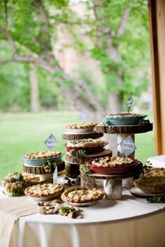 a table topped with lots of pies and pie dishes