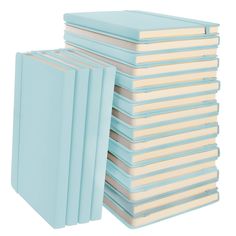 a stack of blue books sitting next to each other on top of a white surface