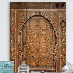 an ornate wooden door in the middle of a room with many decorations on it and other items