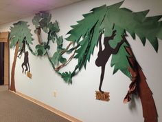 an office wall decorated with paper cutouts and jungle animals on it's sides