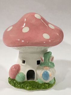 a ceramic mushroom house with polka dots on it