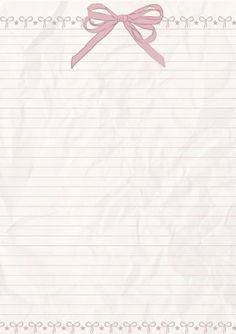 a notepad with a pink ribbon and bow on the top is lined in white paper