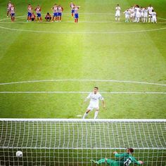 the soccer players are playing on the field in front of the goalie's