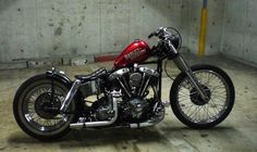 a red and black motorcycle parked in a garage