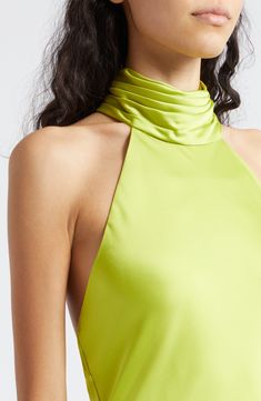 a woman wearing a lime green halter top