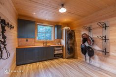 a wood paneled laundry room with lots of storage