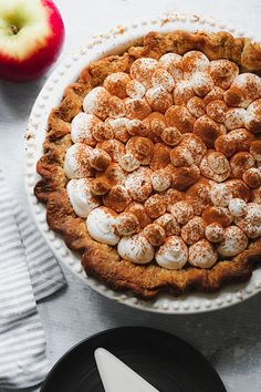 an apple pie with marshmallows and powdered sugar in the crust on top