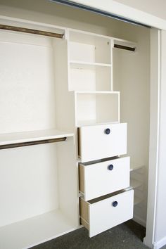 an empty closet with white drawers and shelves