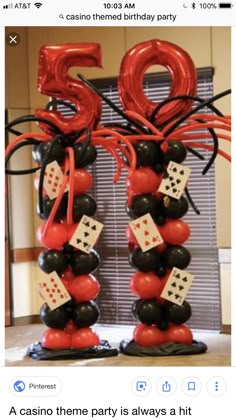 the balloon columns are decorated with black, red and white balloons that spell out the number 50