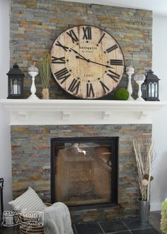 a fireplace with a large clock above it