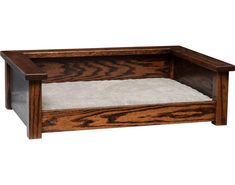 a dog bed made out of wood with a white rug in the bottom and bottom