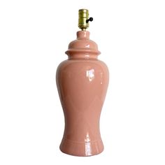 a pink ceramic urn with a gold top on a white background for decoration or as a vase