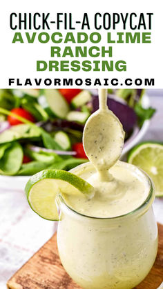 an avocado lime dressing in a small glass jar with a spoon sticking out of it