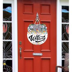 a red door with a welcome sign on it