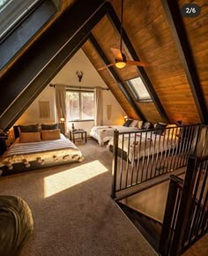 an attic bedroom with two beds and a loft