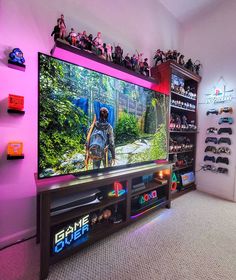 a large flat screen tv sitting on top of a entertainment center