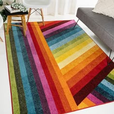 a multicolored area rug in a living room with a couch and chair next to it