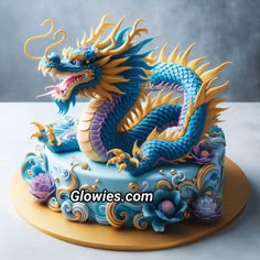 a blue and yellow cake with a dragon on top