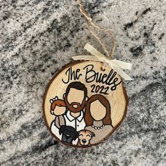 a wooden ornament with an image of two people and a dog on it