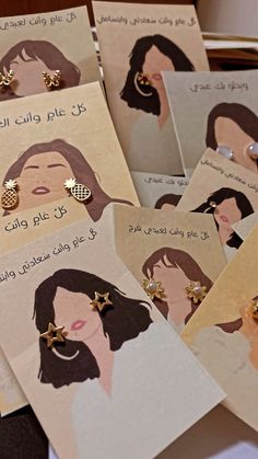 several cards with pictures of women wearing hair and gold earrings on top of each card