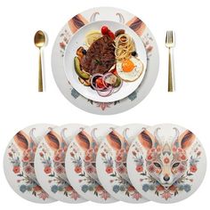 an assortment of dinner plates and utensils on a white plate with floral designs