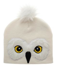 a white owl hat with yellow eyes