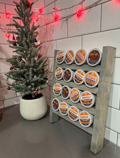 a small christmas tree in front of a display of frosted chocolates