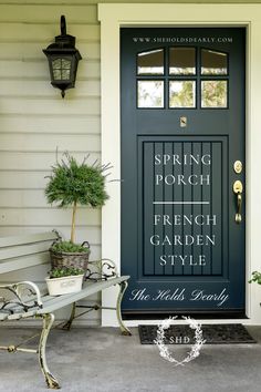 a black front door with the words spring porch french garden style on it and a bench in front