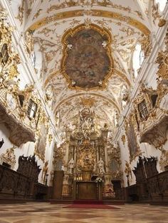 the inside of a church with gold and white decorations on the ceiling, walls and ceilings