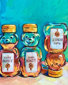 three honey jars are sitting next to each other on a table with blue and green background