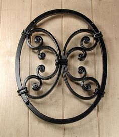 a circular metal wall hanging on a wooden floor