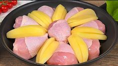 raw chicken and sliced bananas in a skillet