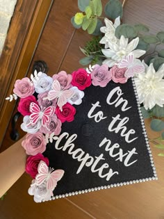 a graduation cap decorated with paper flowers and the words one to the next teacher