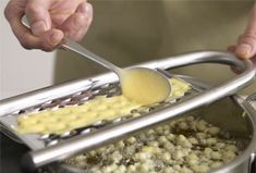 a person is using a ladle to stir food