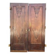 two wooden doors with carvings on them