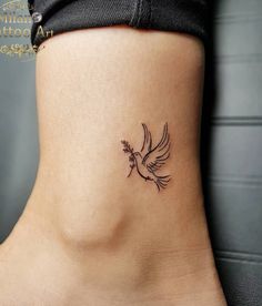 Pretty Dove Ankle Tattoo Idea Bird Tatoos Woman Wrist, Small Dove Tattoo Design For Women, Dove With Olive Branch Tattoo Simple, Dainty Dove Tattoo, Dove Flying Tattoo, Angel Tattoo Placement, Cross With Birds Tattoo, Dove Hand Tattoo