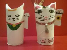 two white paper cups with cats on them