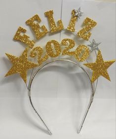 a headband with gold glitter stars and the words sale 2009 on it's side