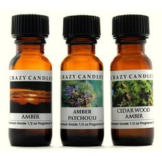 three bottles of crazy candles ambree and patchoui essential oil on a white background