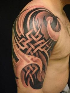 a man's arm with an intricate tattoo design on the arm and shoulder area