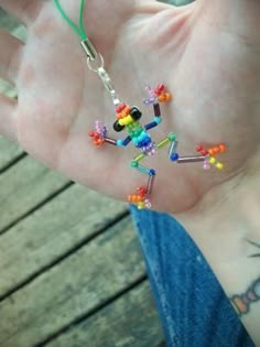 a person's hand holding some colorful beads