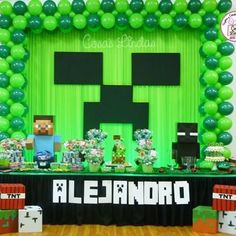 an image of a table set up for a minecraft birthday party with balloons and decorations