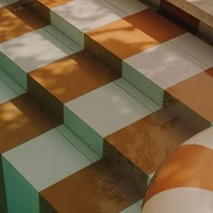 an orange and white checkered floor with steps