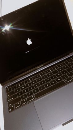 an open laptop computer sitting on top of a table