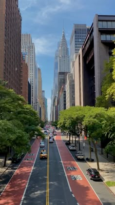 an empty city street with tall buildings in the background