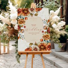 an easel with a floral wedding sign on it