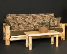 a living room with couch, coffee table and potted plant on the end tables