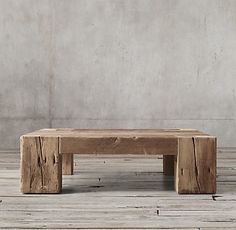 a wooden bench sitting on top of a wooden floor in front of a concrete wall