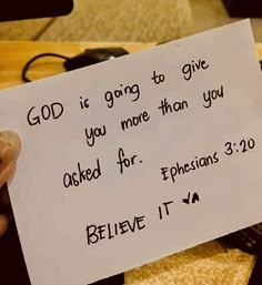 someone holding up a paper with the words god is going to give you more than you asked for