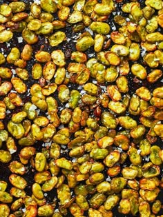 roasted brussel sprouts in oil on a baking sheet, top view